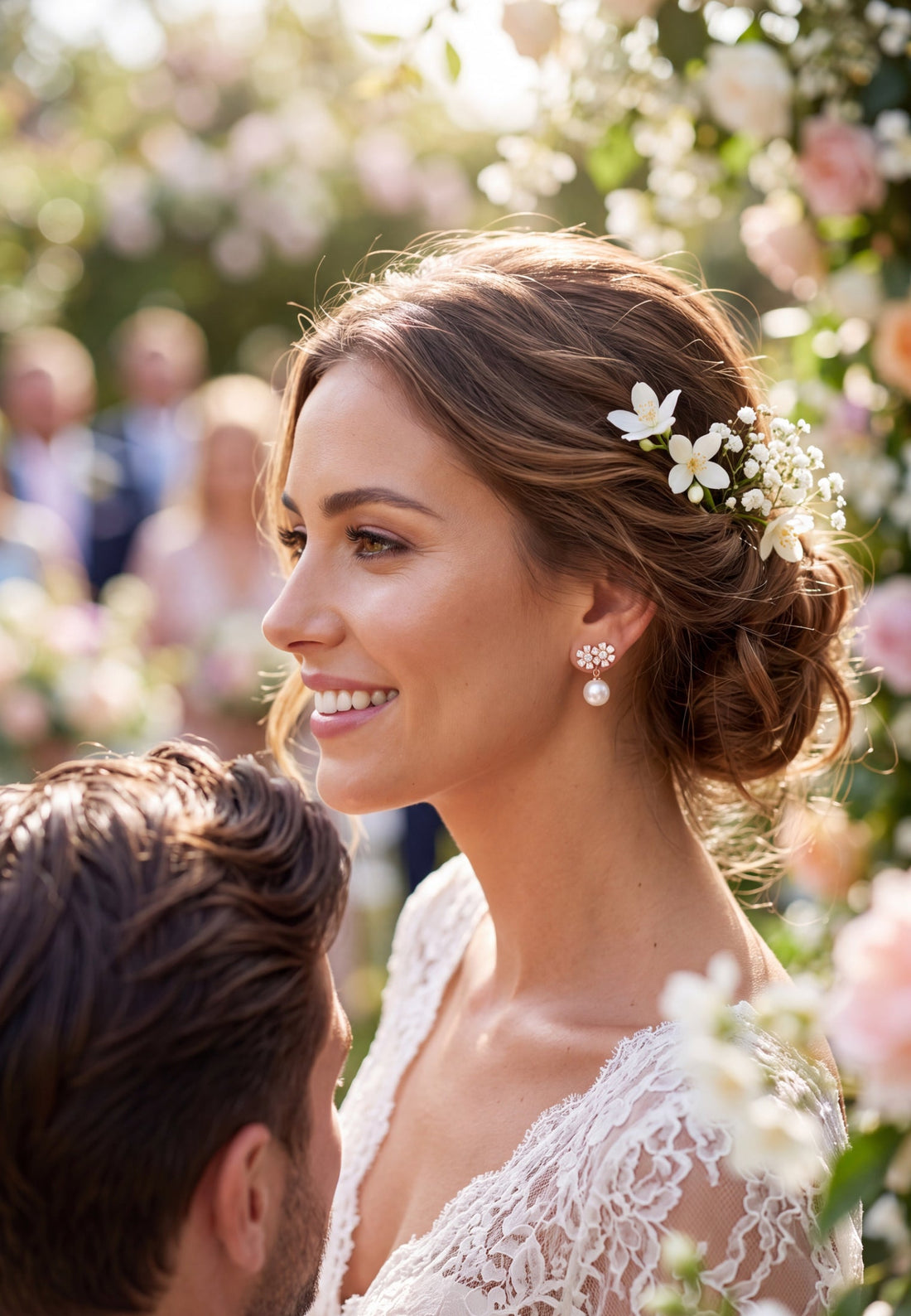 Gold-tone pearl drop earrings with crystal flower clusters, worn with bridal hairstyle