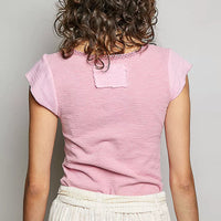 Soft pink lightweight knit top with short sleeves, back view and stitched neckline