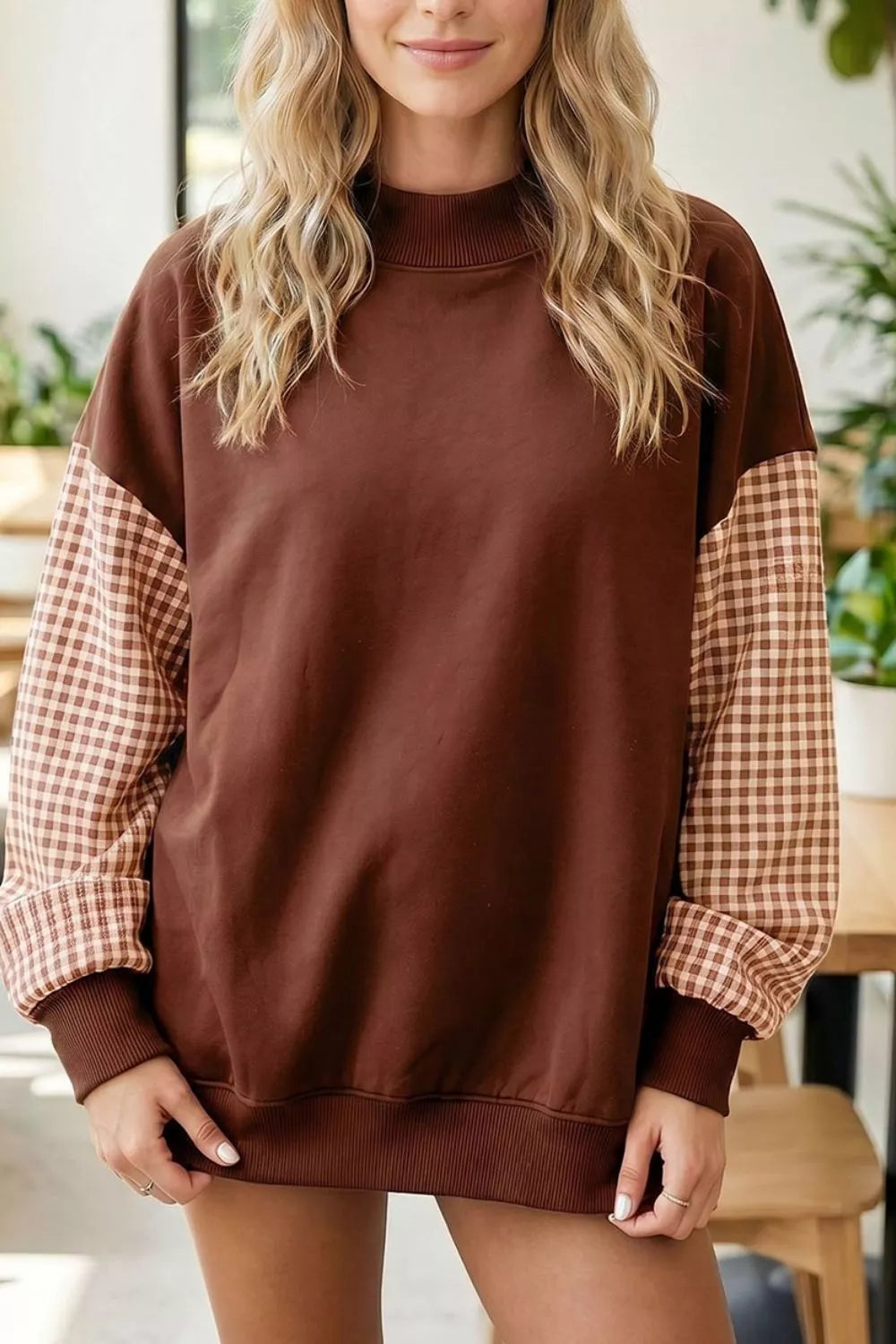 Dark brown loose tunic sweatshirt with plaid check sleeves and ribbed crew neck