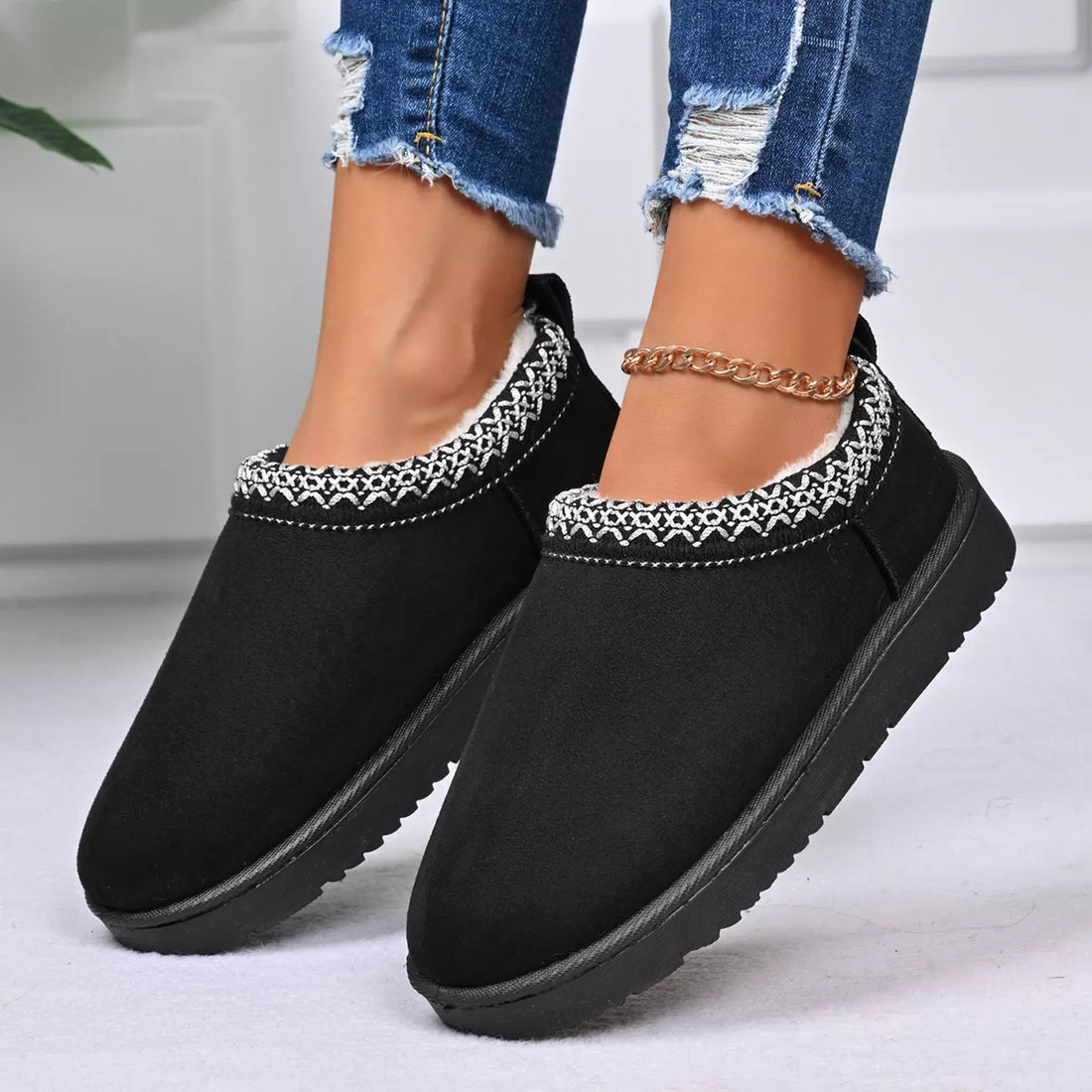 Black platform ankle boots, round toe, decorative patterned trim at the opening