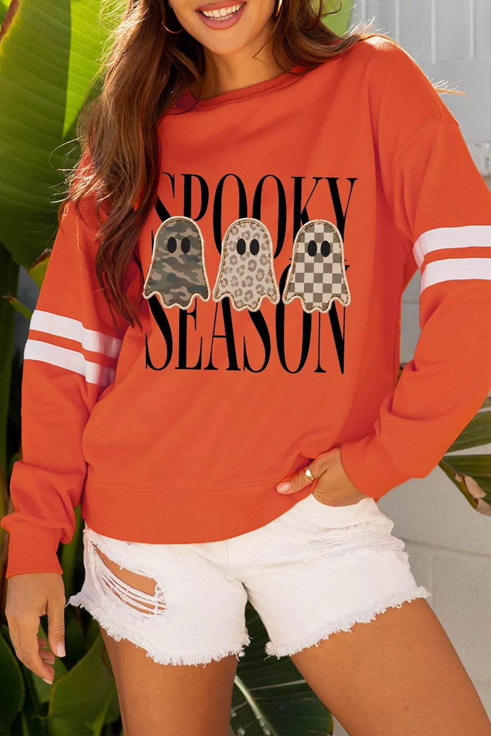 Orange ghost graphic pullover sweatshirt with varsity striped sleeves
