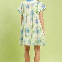 Floral babydoll dress back view, blue-trimmed cap sleeves and tiered skirt