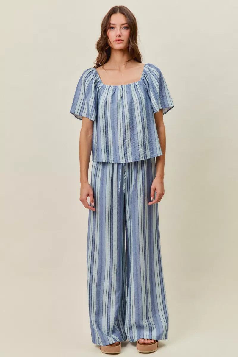 Blue striped wide-leg pants with elastic waist and loose, draped fit