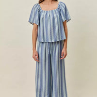 Blue striped wide-leg pants with elastic waist and loose, draped fit