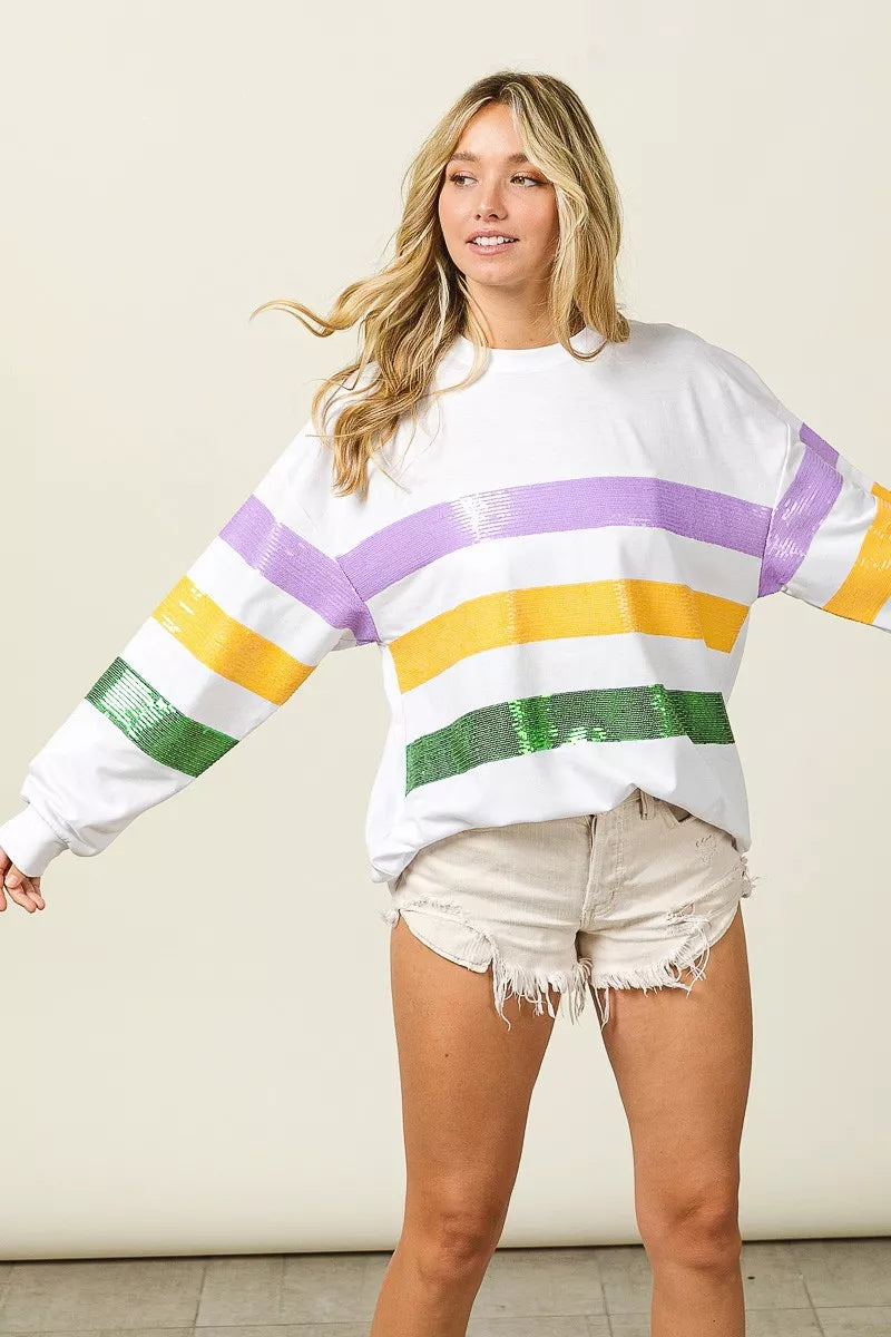 White sweatshirt with sequin horizontal stripes in purple, yellow, and green, long sleeves