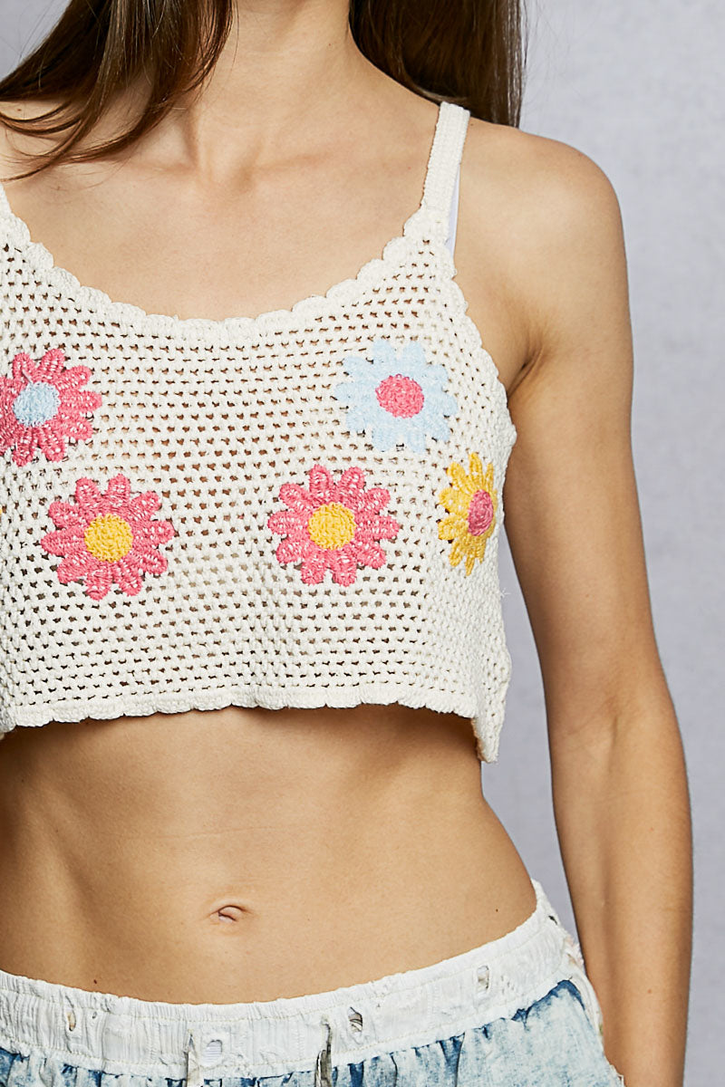 Close-up of ivory crochet cropped cami with multicolor floral embroidery detail