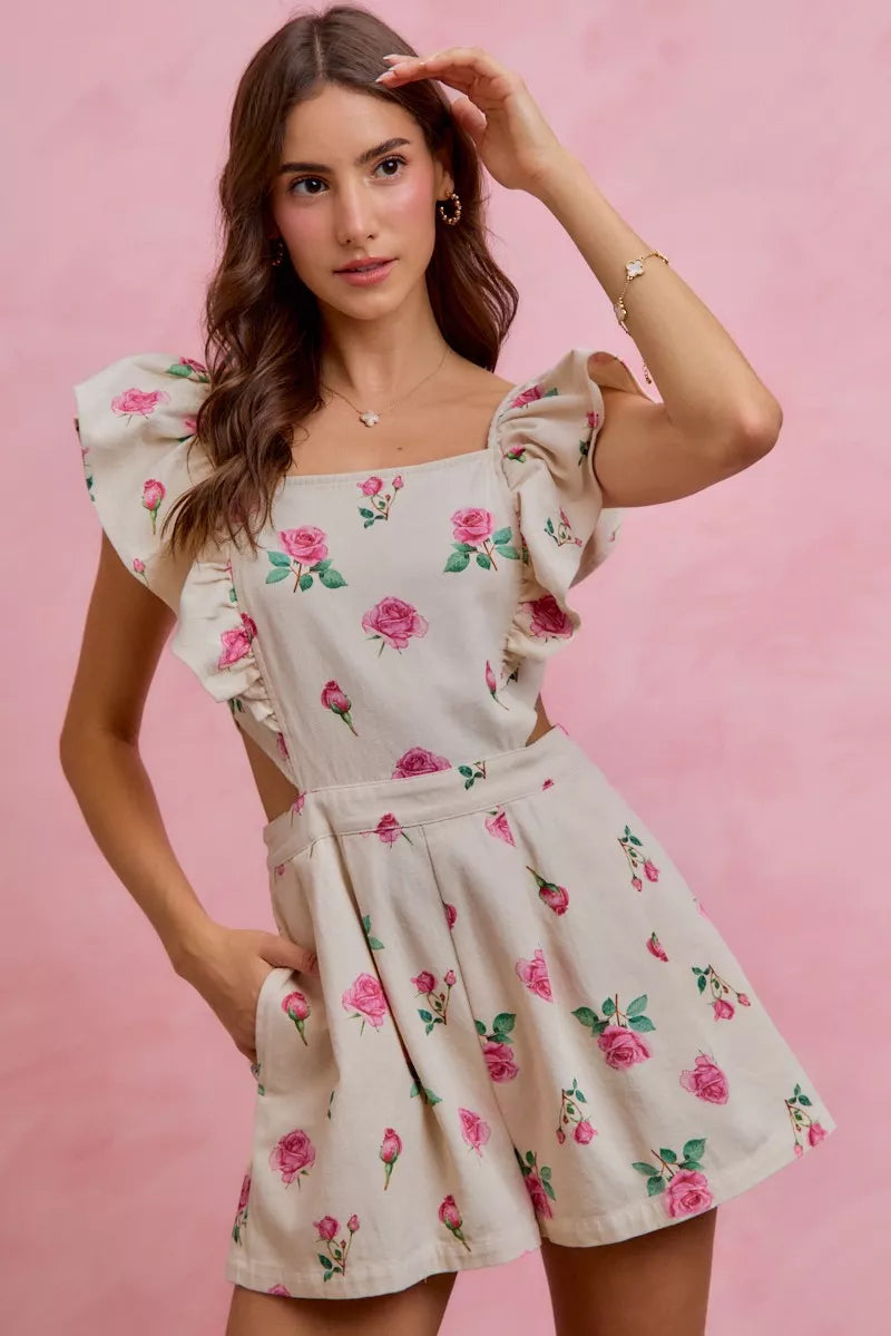 Ivory floral romper with ruffled cap sleeves, pleated waist and pink rose print