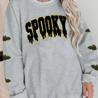 Gray Halloween sweatshirt with sequin 'SPOOKY' front print and bat-pattern sleeve cuffs