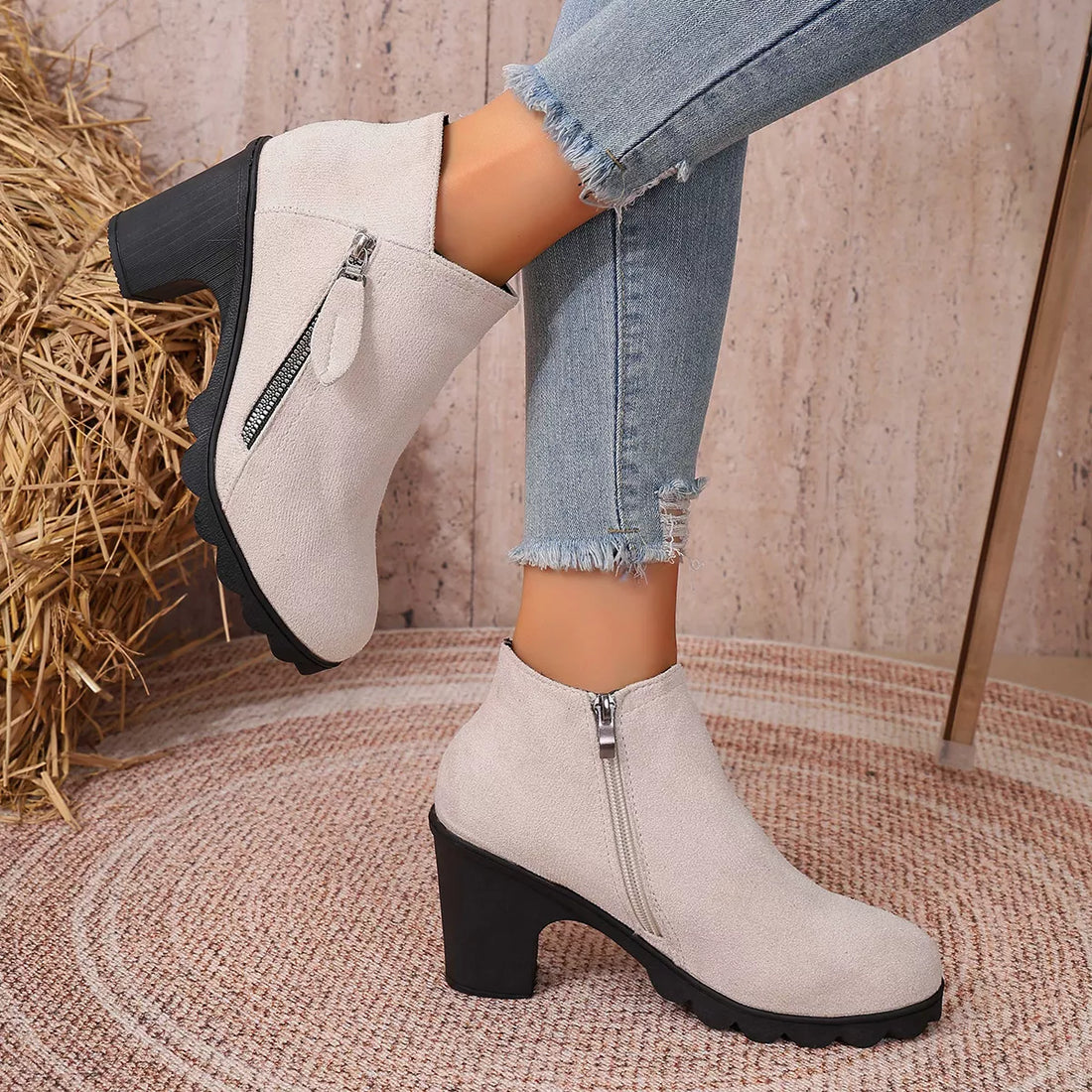 Beige suede ankle boots with round toe, block heel, and side zipper closure