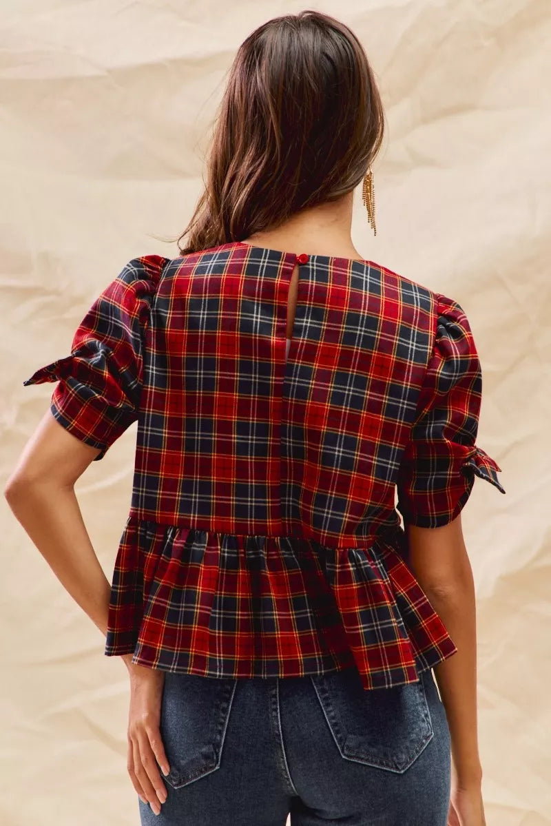 Back view red plaid peplum top with ribbon-tied short puff sleeves