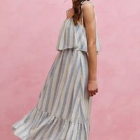 Front three-quarter view of sleeveless vertical stripe midi dress with tiered ruffle skirt