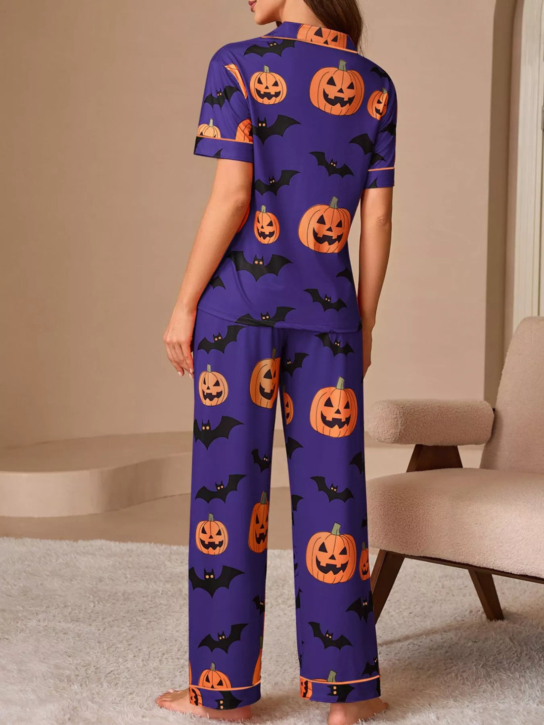 Halloween pajama set: purple button-front top and pants with orange pumpkin and bat repeat print