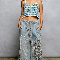 Blue crocheted cropped cami with scalloped hem and thin straps, front view