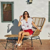 Off-white knit dolman sweater with red, white, and blue ribbon bows at neckline
