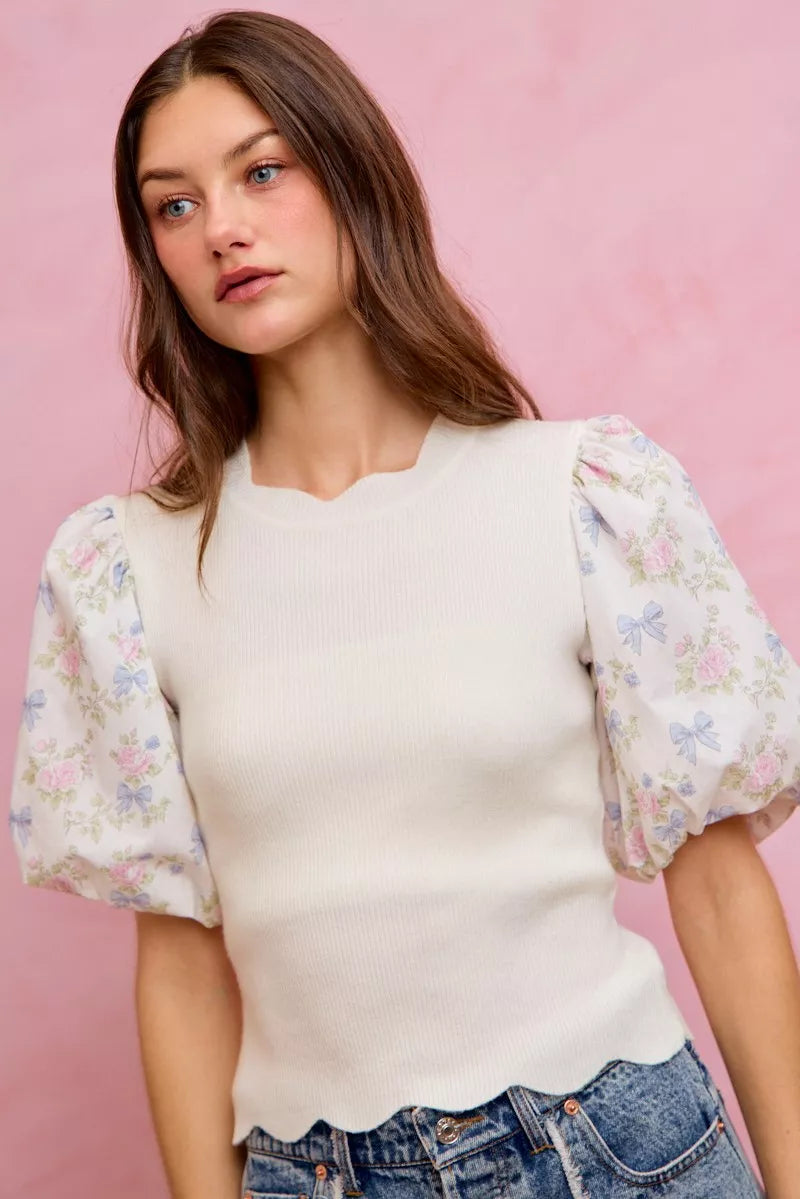 White knit crewneck sweater top with floral puff sleeves and scalloped hem