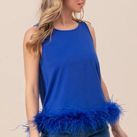 Royal blue sleeveless top with shaggy faux feather trim hem, side view