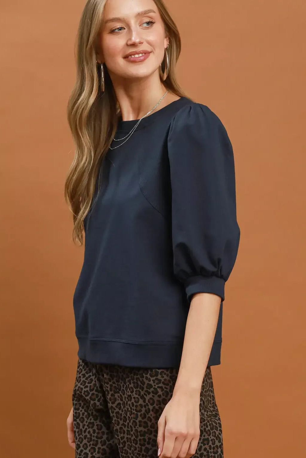 Navy crewneck sweatshirt with puff sleeves and relaxed hem