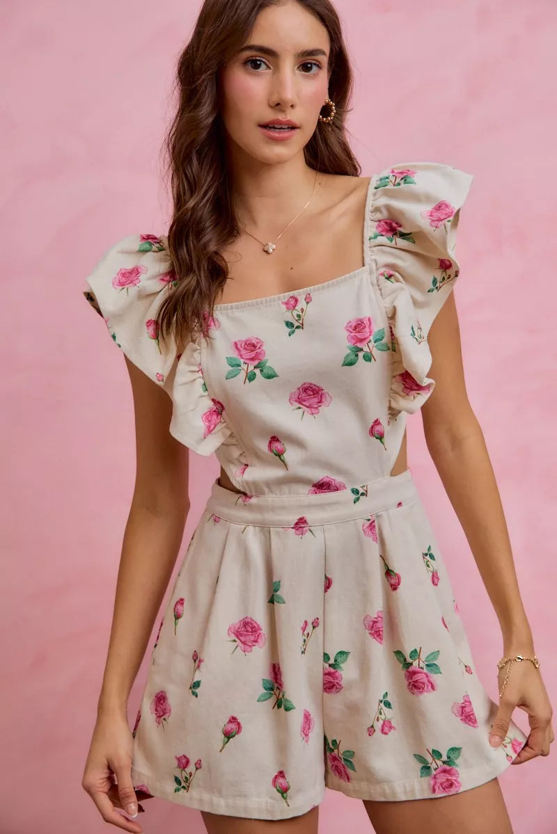 Ivory floral romper with ruffled cap sleeves and gathered waist, pink rose print