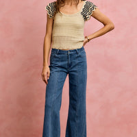Oatmeal wavy textured knit top with flutter sleeves and zigzag black trim