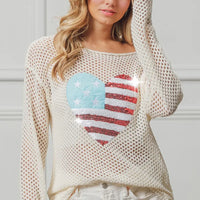 Off-white sequin knit sweater with American flag heart graphic, long sleeves.