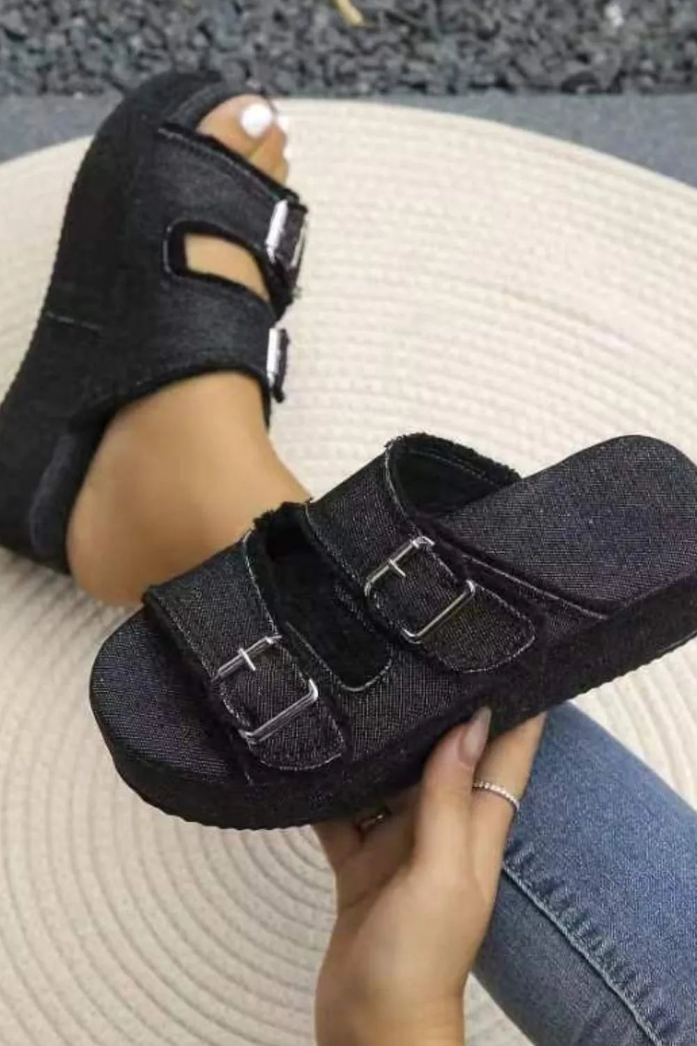 Black fabric wedge sandals with two hook-and-loop straps and metal buckle accents