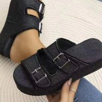 Black fabric wedge sandals with two hook-and-loop straps and metal buckle accents