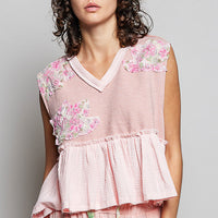 Powder pink sleeveless top with V-neck, floral patchwork and peplum ruffle
