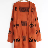 Orange open-front knit cardigan with black pumpkin jack-o'-lantern print, front view