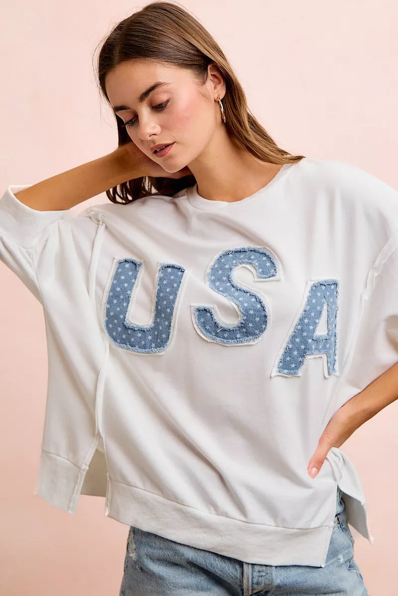 Ivory french terry top with appliqued blue "USA" letters, loose fit and short sleeves