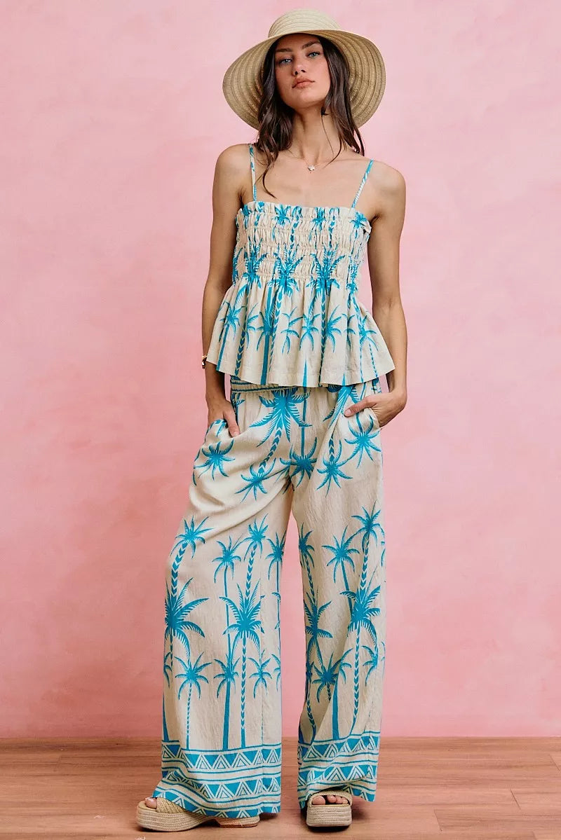 Blue palm-print smocked cami top with straight neckline, adjustable straps, peplum hem