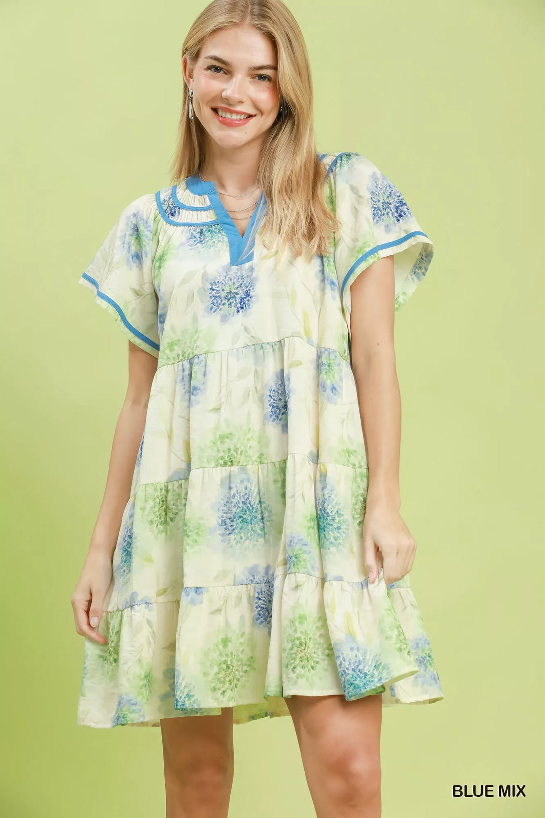 Floral babydoll dress with blue trim and tiered skirt, light cream base