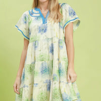 Floral babydoll dress with blue trim and tiered skirt, light cream base