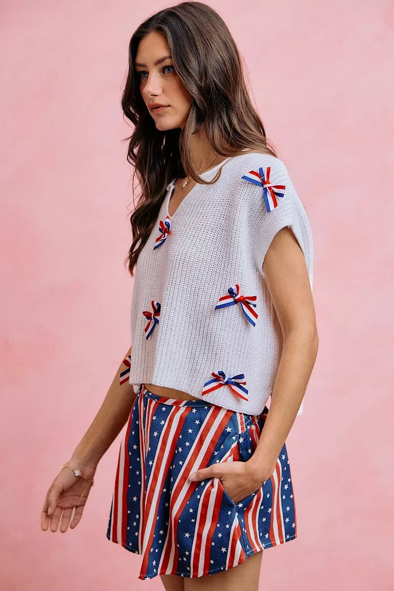 Off-white dolman sweater top with red, white & blue ribbon bow trim