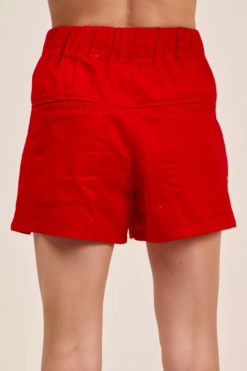 Red twill denim shorts with pintucked back yoke and elastic waistband.