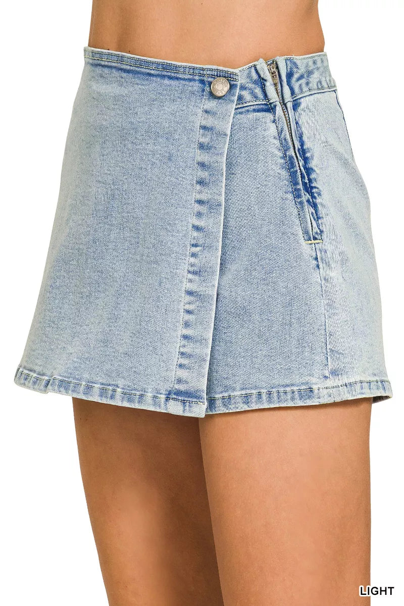 Light wash denim skort with wrap front, button closure, and utility pocket detail