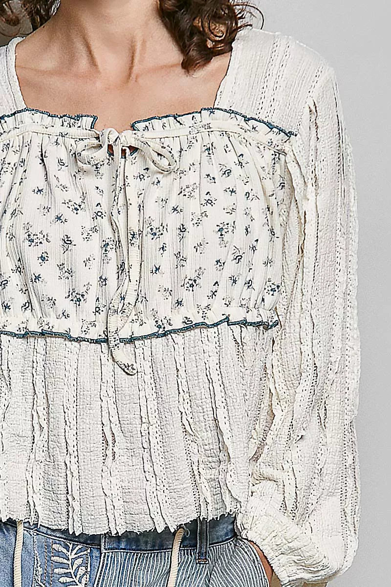 Cream lace square-neck bodice with drawstring tie, blue-trim edge and tiny floral print