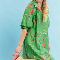 Green floral mini dress with V-neck and puff sleeves, side view with knee-length hem