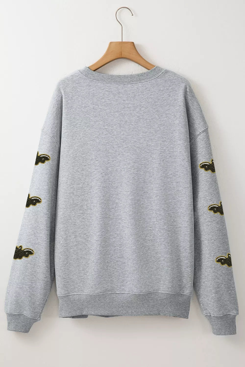 Gray Halloween sweatshirt back view with bat-pattern sleeve accents