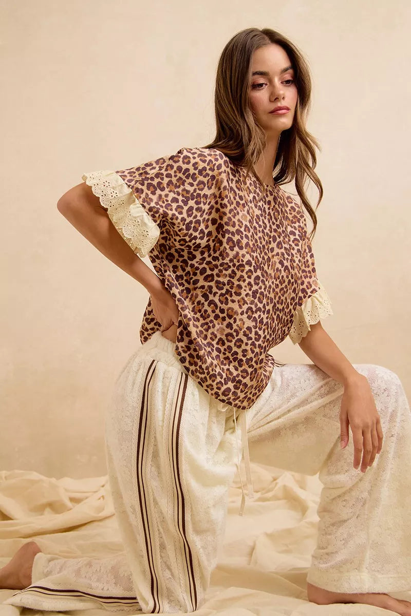 Leopard print top with lace-trimmed sleeves paired with cream striped shorts