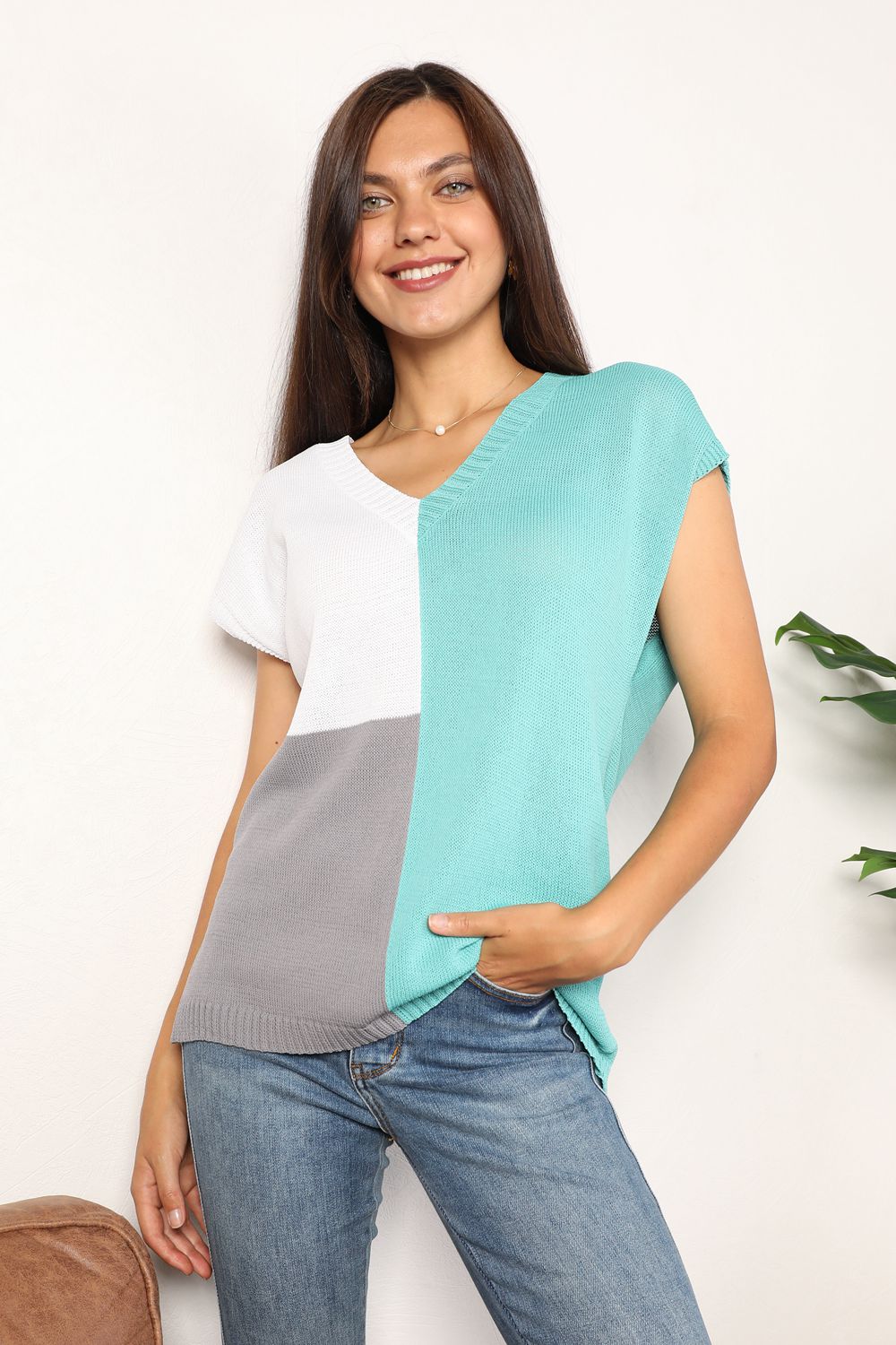 Turquoise and white color-block V-neck knit top with short sleeves and knit texture.