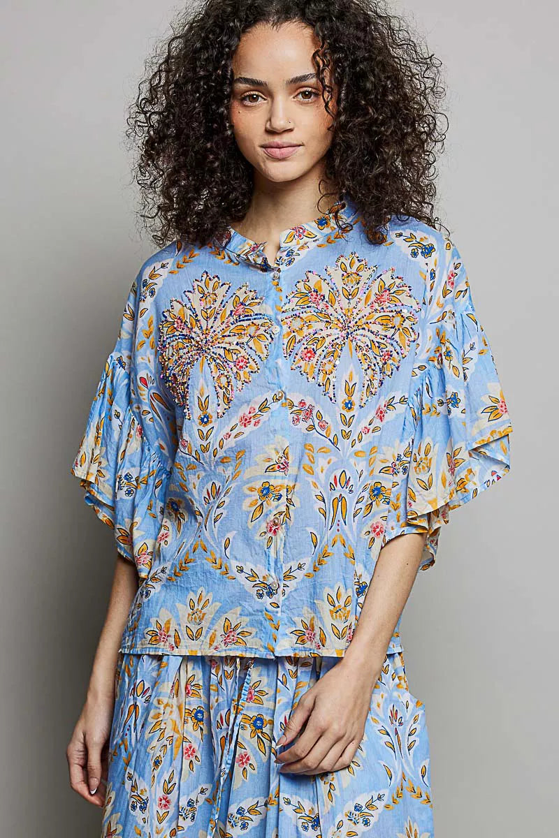 Blue floral printed woven ruffle-sleeve shirt with elastic waist, close front view