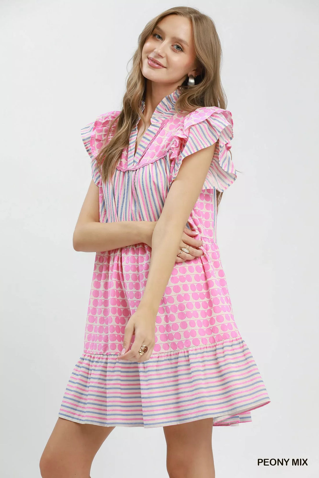 Pink and striped tiered dress with flutter sleeves and dot skirt, side view