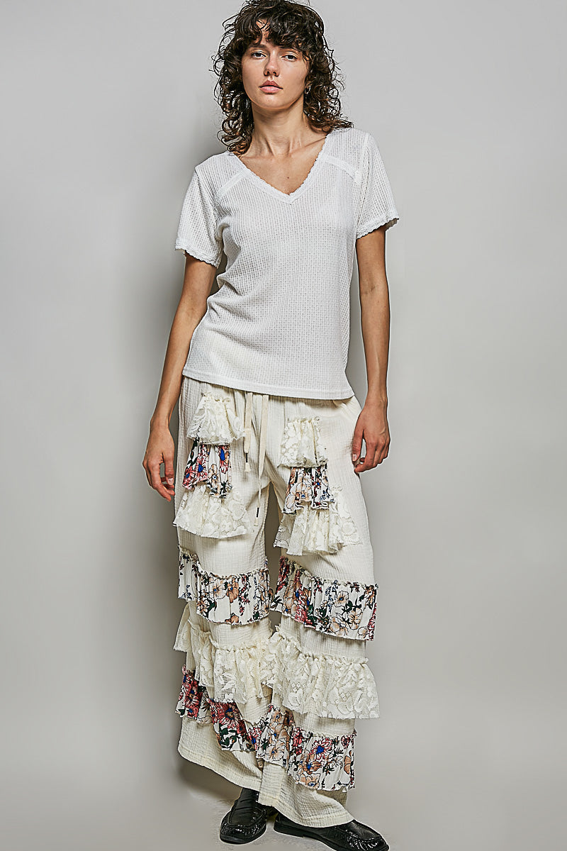 Off-white textured V-neck short-sleeve t-shirt with tiered ruffle skirt, full body