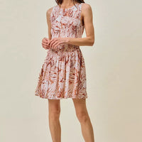 Coral and white shell-print mini dress with smocked waist, fit-and-flare silhouette