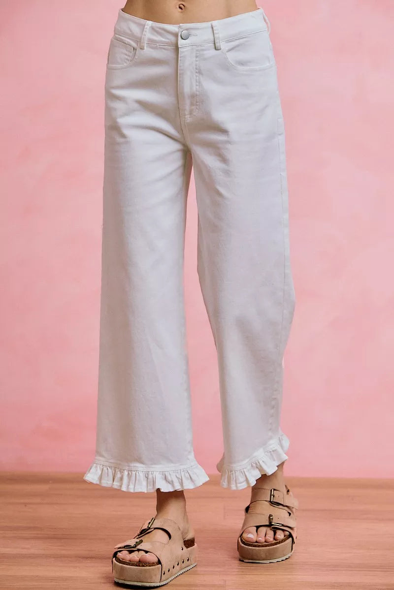 White mid-rise wide-leg jeans with ruffled hem detail