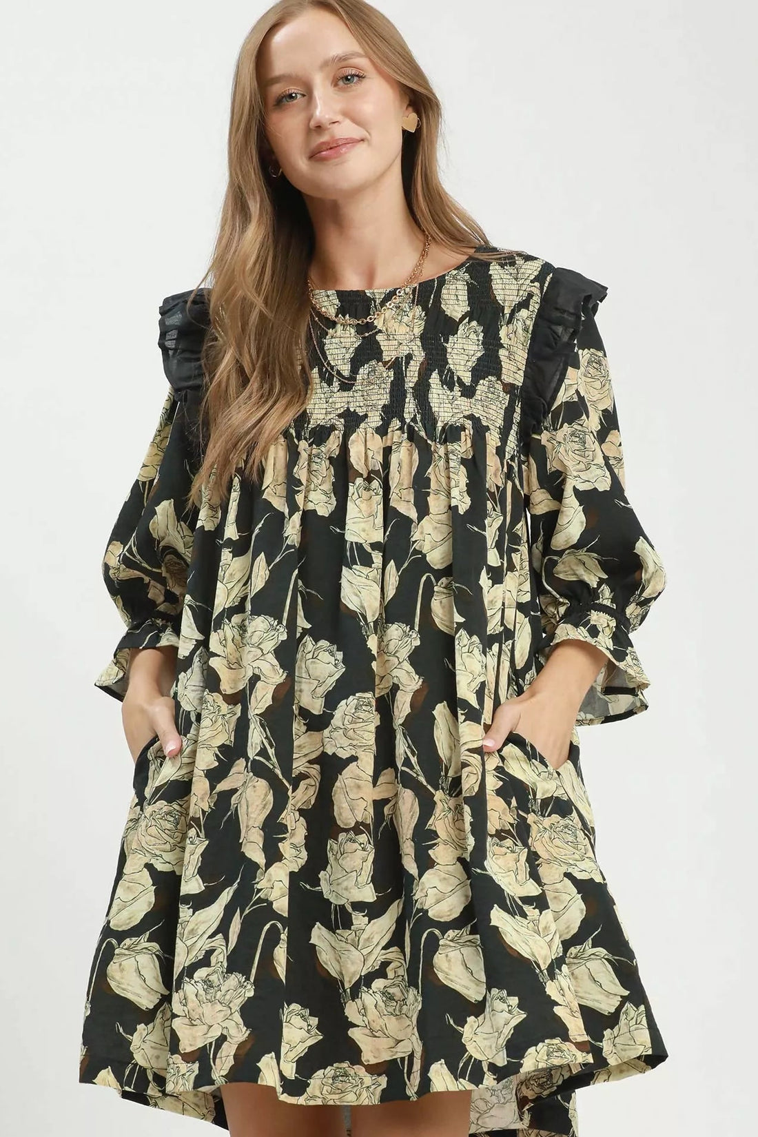 Black-and-cream floral smocked ruffle dress with loose flowy skirt