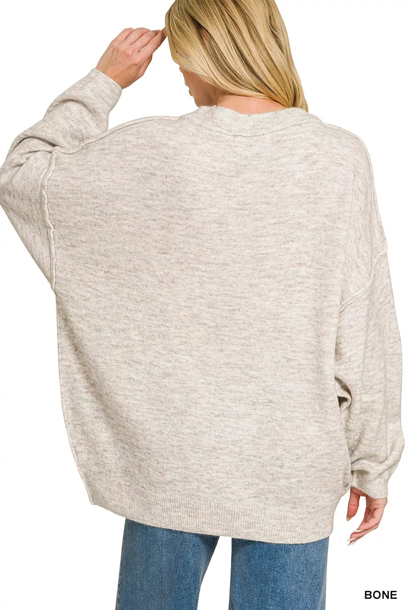 Oversized bone melange sweater back view with round neck and exposed side seams