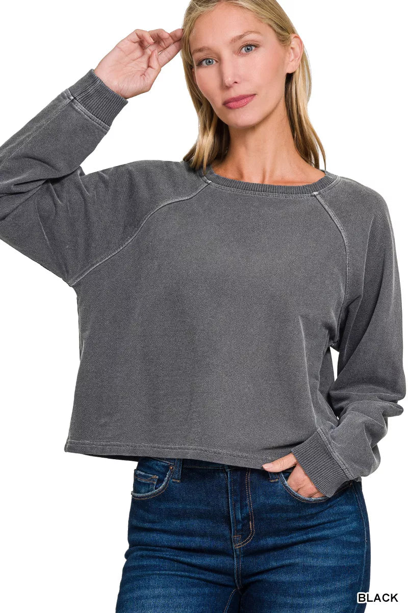 Dark gray round-neck pullover with long sleeves, close-up