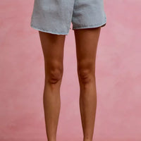 Light blue denim skort with button fly, belt loops, and front pockets
