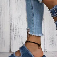 Blue denim wedge sandals with two adjustable straps and metal buckle hardware